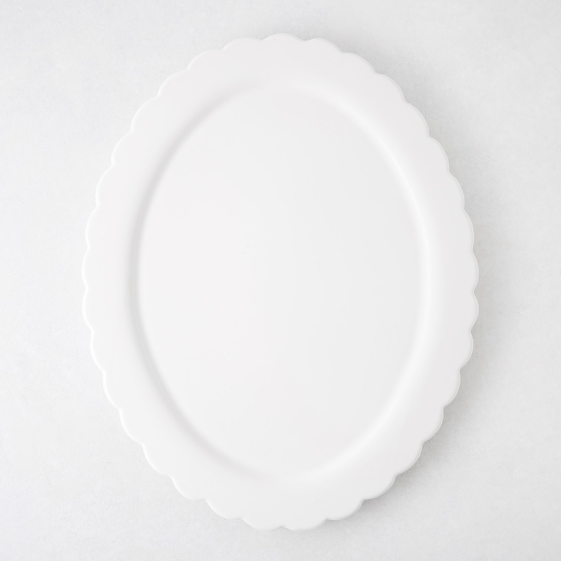 White ceramic Scallop Oval Serving Platter, 17.72"L x 14.17"W, with a scalloped edge.