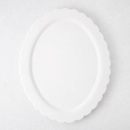 White ceramic Scallop Oval Serving Platter, 17.72"L x 14.17"W, with a scalloped edge.