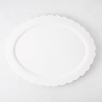 White ceramic Scallop Oval Serving Platter, 17.72"L x 14.17"W, with a subtle scalloped edge.