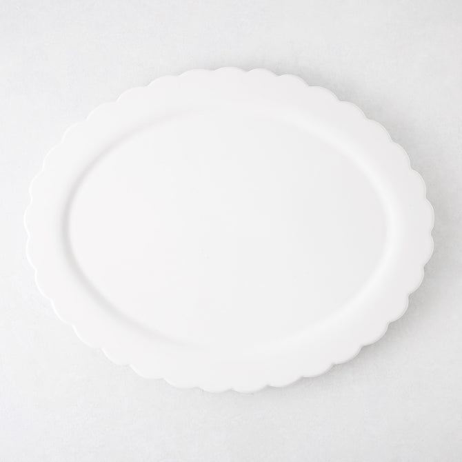 White ceramic Scallop Oval Serving Platter, 17.72"L x 14.17"W, with a subtle scalloped edge.