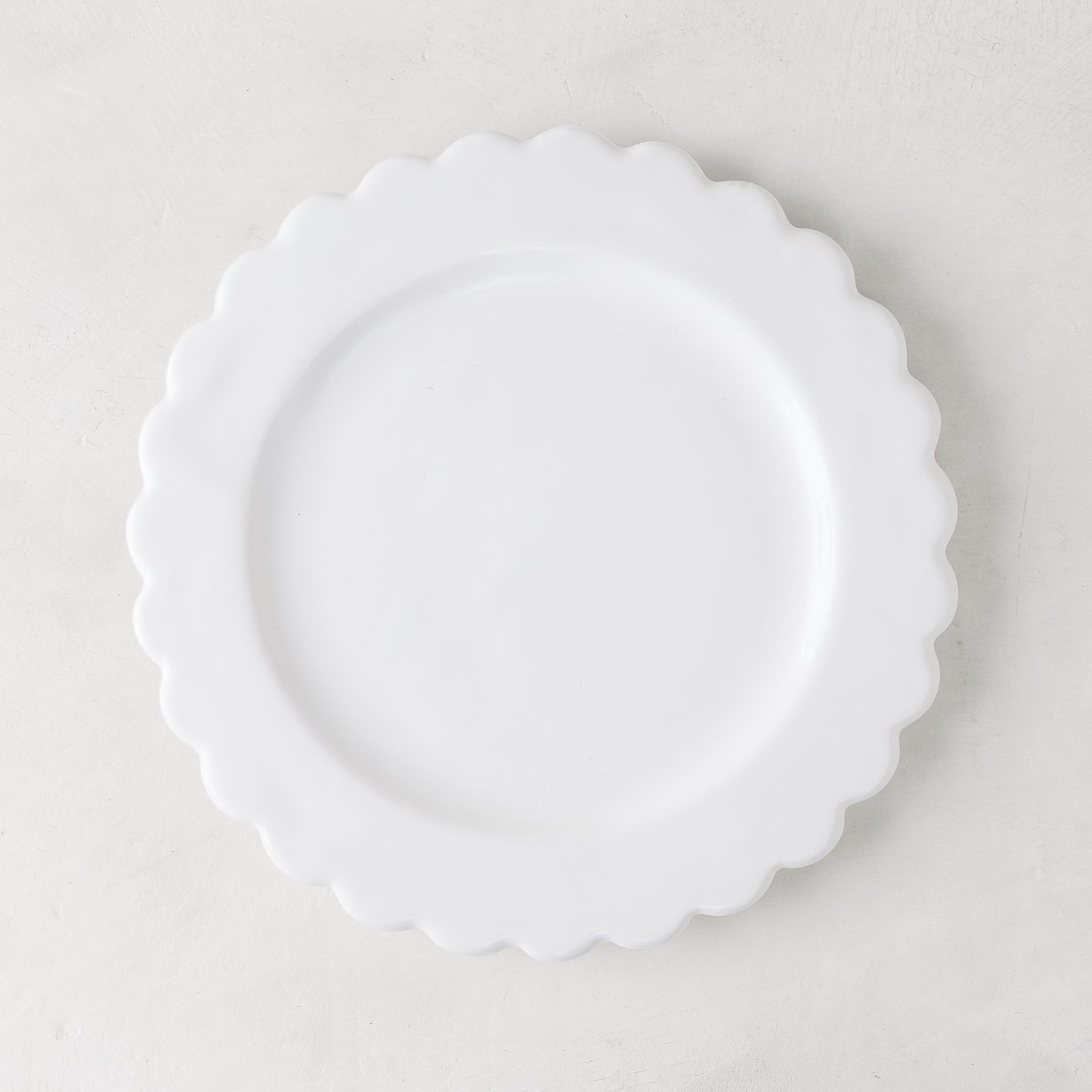 White ceramic scalloped salad plate, 8.75" diameter, on a light background.