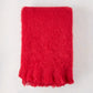 Scarlet Red Solid Mohair Throw Blanket, folded, with fringed edges.
