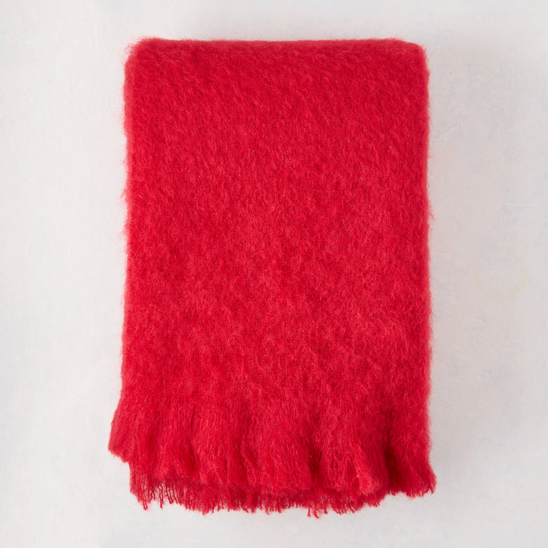Scarlet Red Solid Mohair Throw Blanket, folded, with fringed edges.