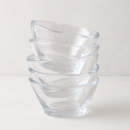 Stack of five clear, handmade glass breakfast bowls with unique scissor-cut tops.