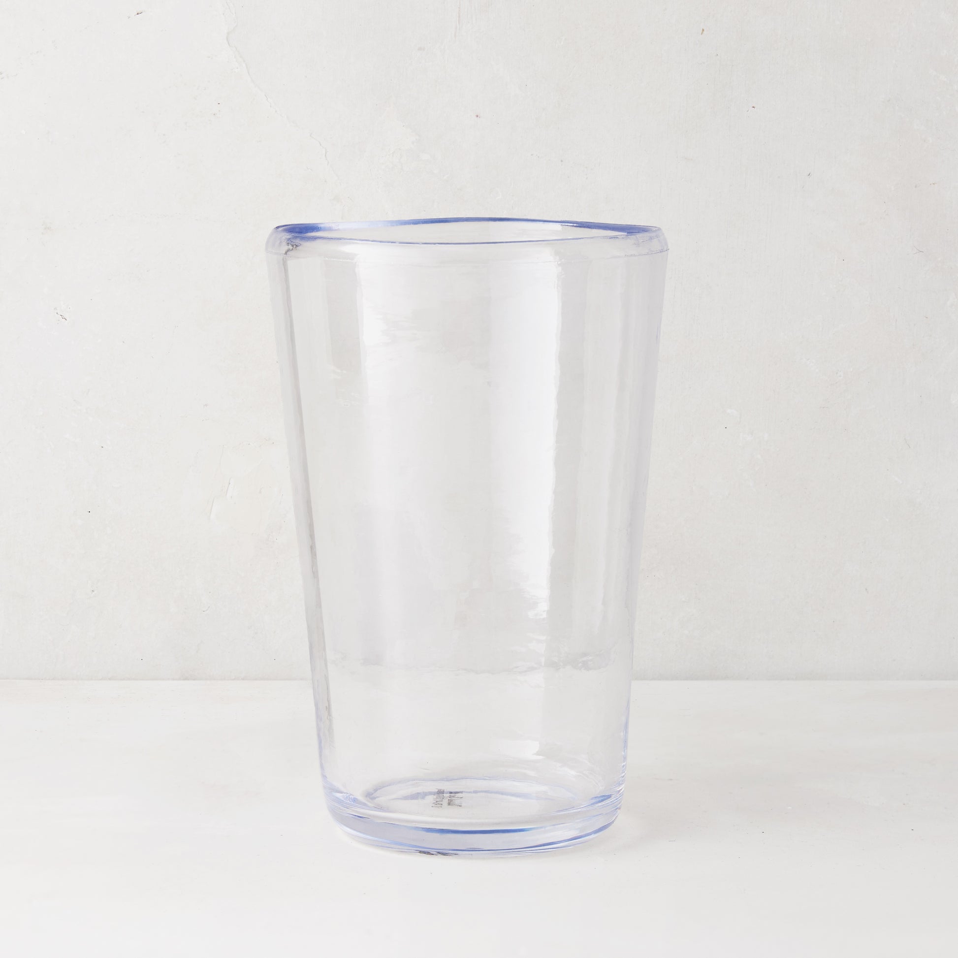 Clear acrylic Seadrift highball glass with a subtle blue rim and base, 19oz.