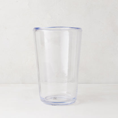 Clear acrylic Seadrift highball glass with a subtle blue rim and base, 19oz.
