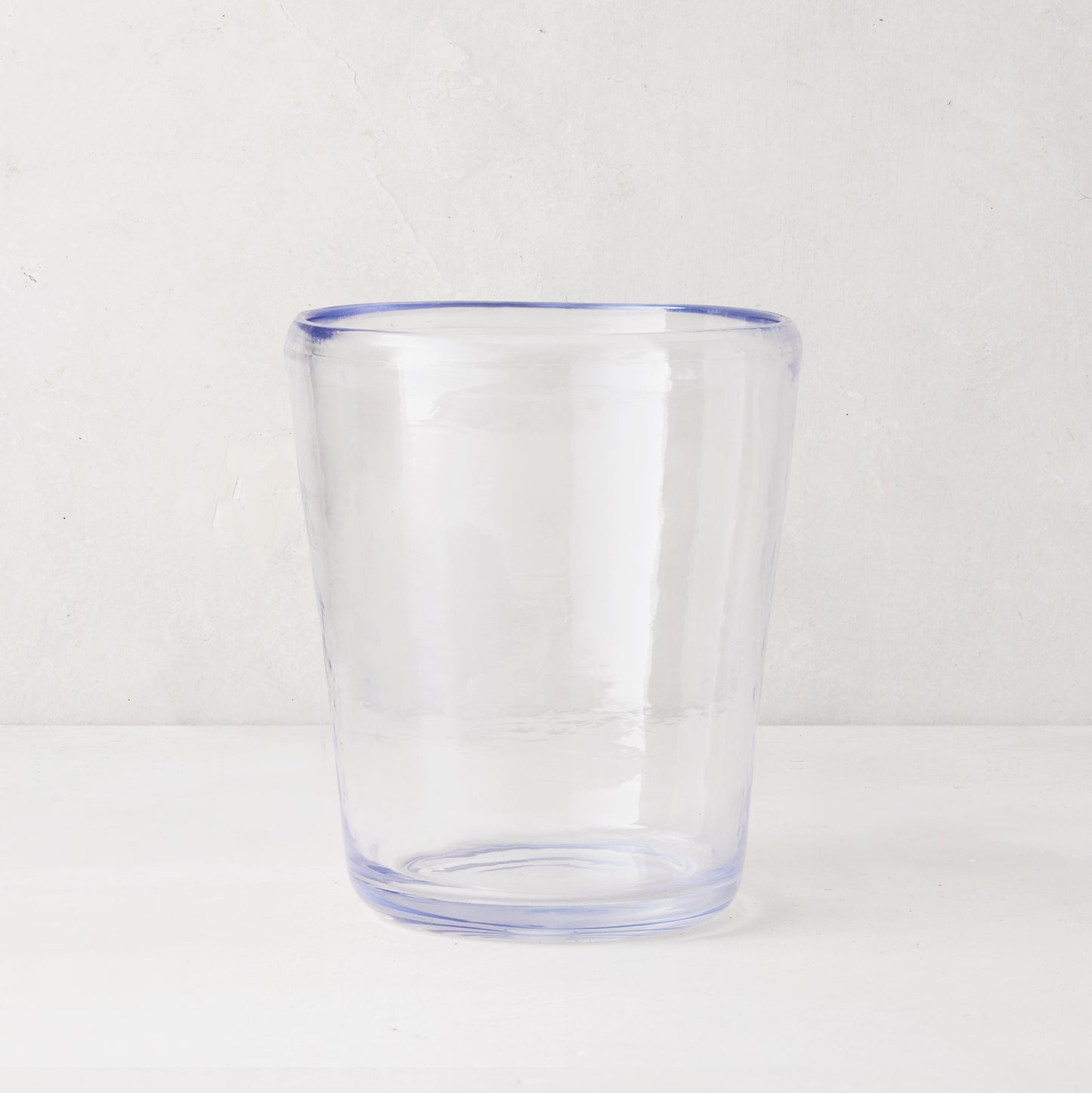 Clear acrylic Seadrift Old Fashioned glass with a subtle blue rim, inspired by Mexican glassware.