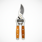 Secateurs with ash wood handles and drop-forged stainless steel blades, featuring a bird logo.
