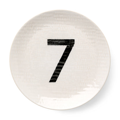 Cream ceramic salad plate with hammered finish and black number 7 graphic, 8.5" diameter.