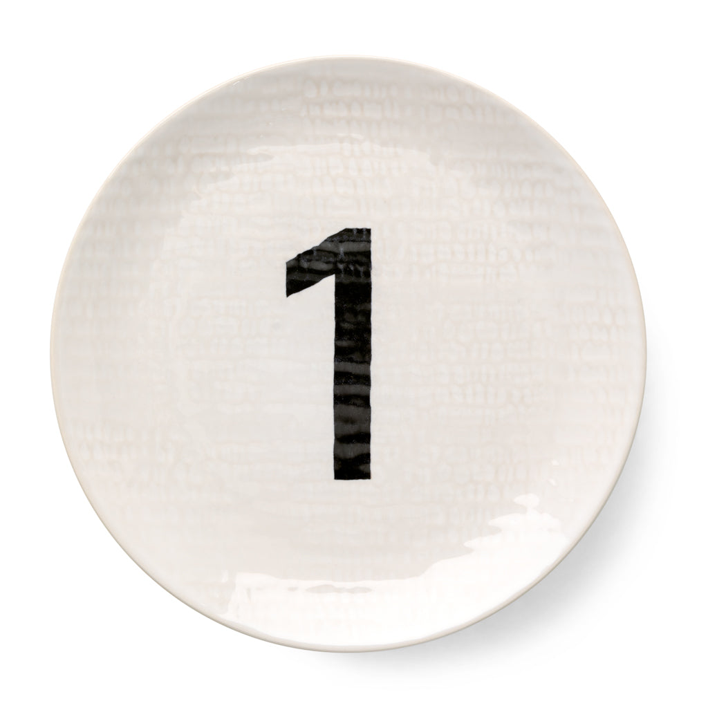 Cream ceramic salad plate with hammered finish and black number "1" design.