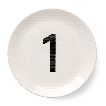 Cream ceramic salad plate with hammered finish and black number "1" design.