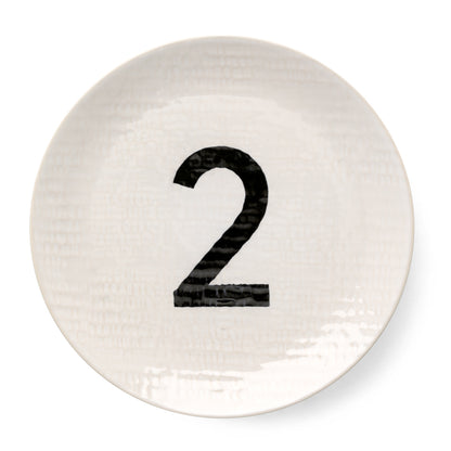 Cream ceramic salad plate with hammered finish and black number 2.