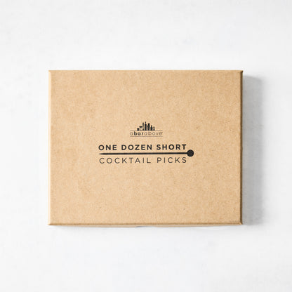 Brown cardboard box for "One Dozen Short Cocktail Picks" by A Bar Above, with black text and logo.