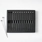 Set of 12 short 4" stainless steel cocktail picks with ball tops, in black foam packaging.