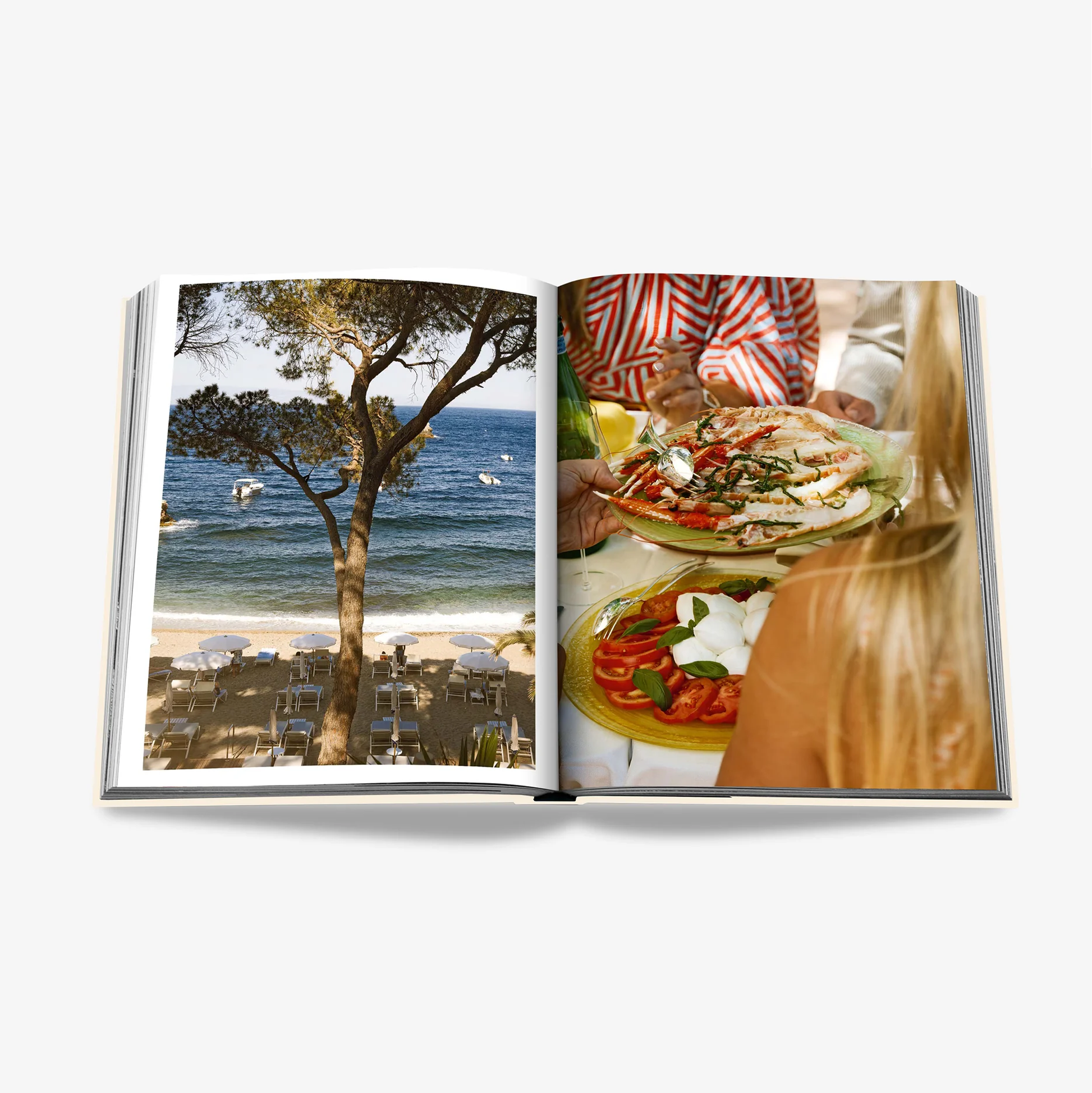 Open "Sicily Honor" linen hardcover book showing a beach scene and people dining on Caprese salad.