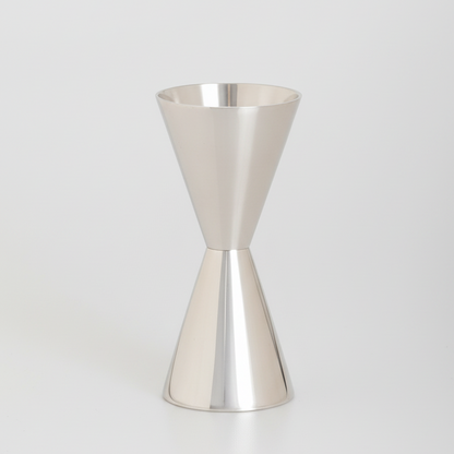 HG Silverplate Double Jigger, a sleek, gleaming two-sided measuring tool for cocktails.