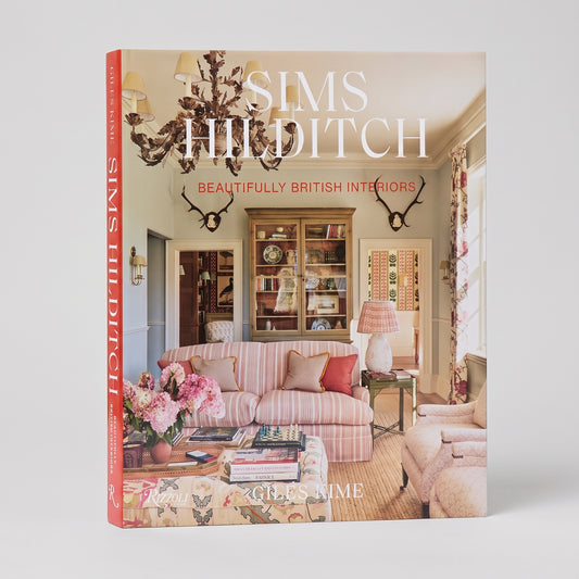 Sims Hilditch hardcover coffee table book featuring a pink striped sofa and elegant British country house interior.