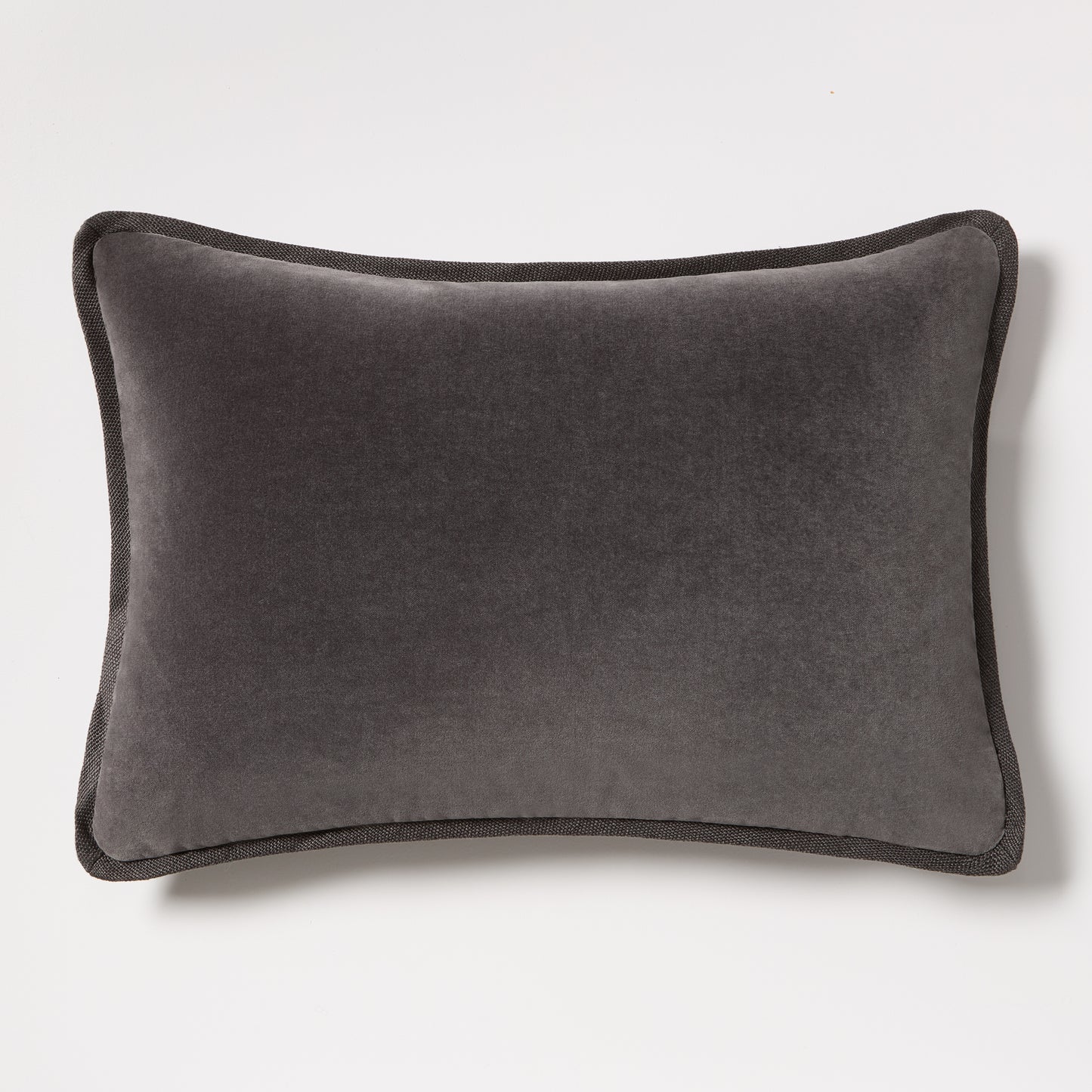 Slate grey tonal reversible velvet and linen lumbar pillow, 20"L x 14"H, with piped edges.