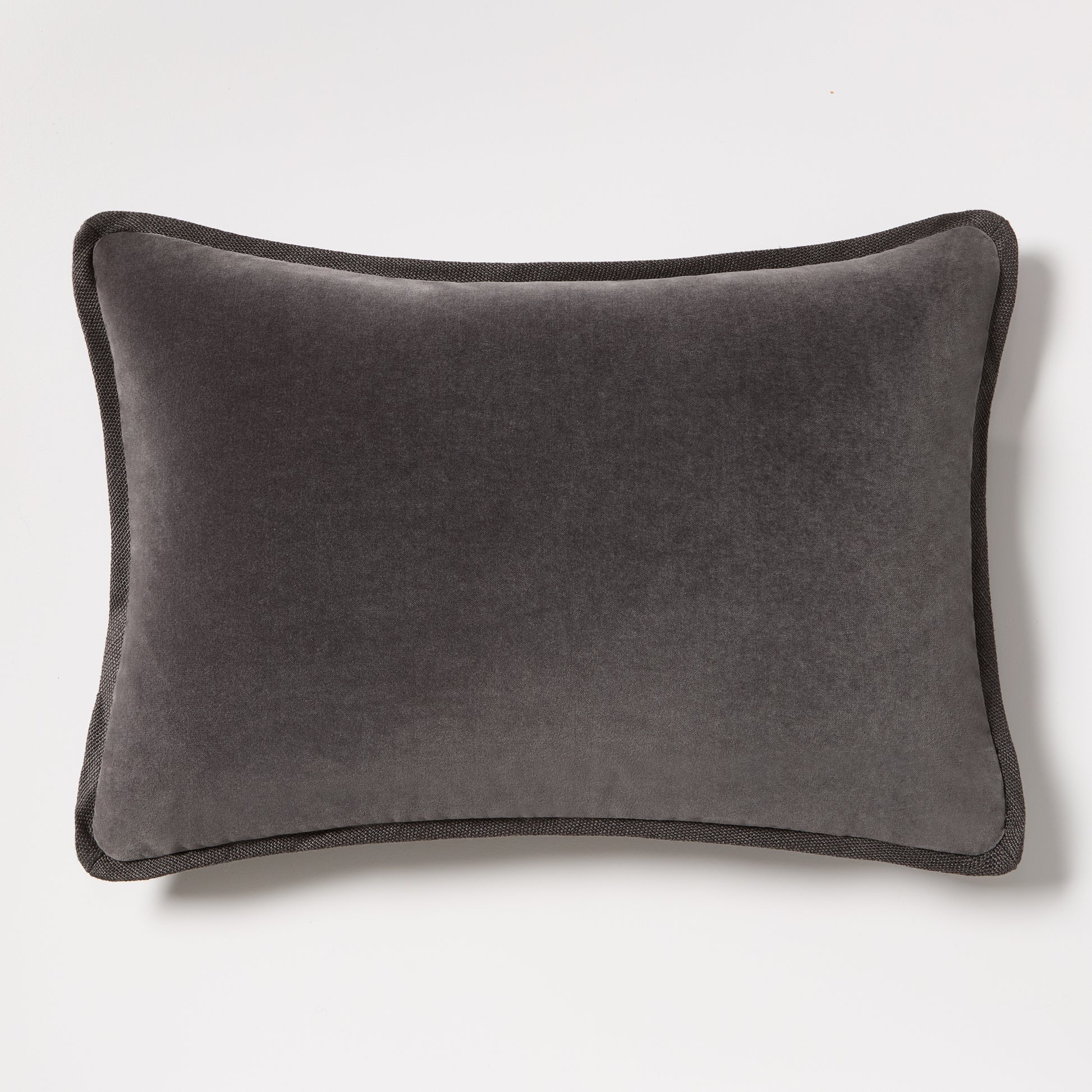 Slate grey tonal reversible velvet and linen lumbar pillow, 20"L x 14"H, with piped edges.