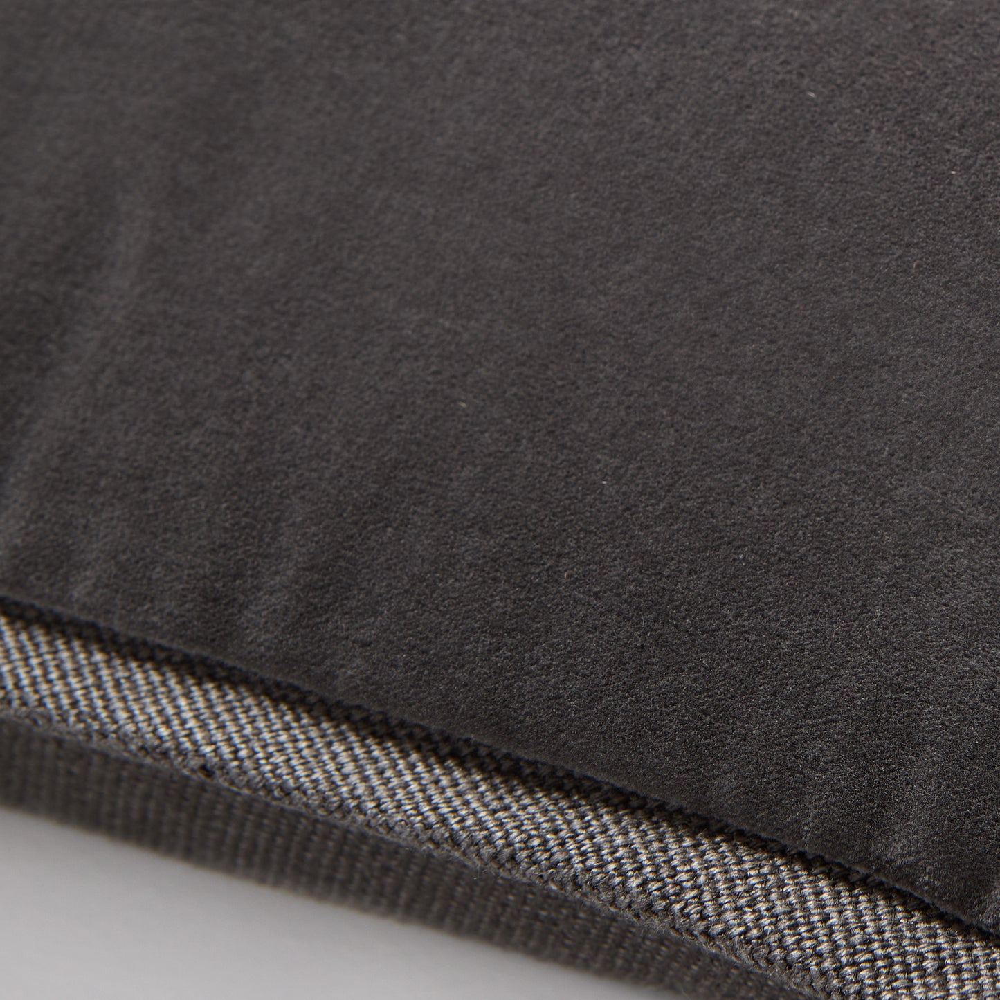 Slate grey tonal reversible velvet and linen lumbar pillow, 20"L x 14"H, with a hidden zipper.