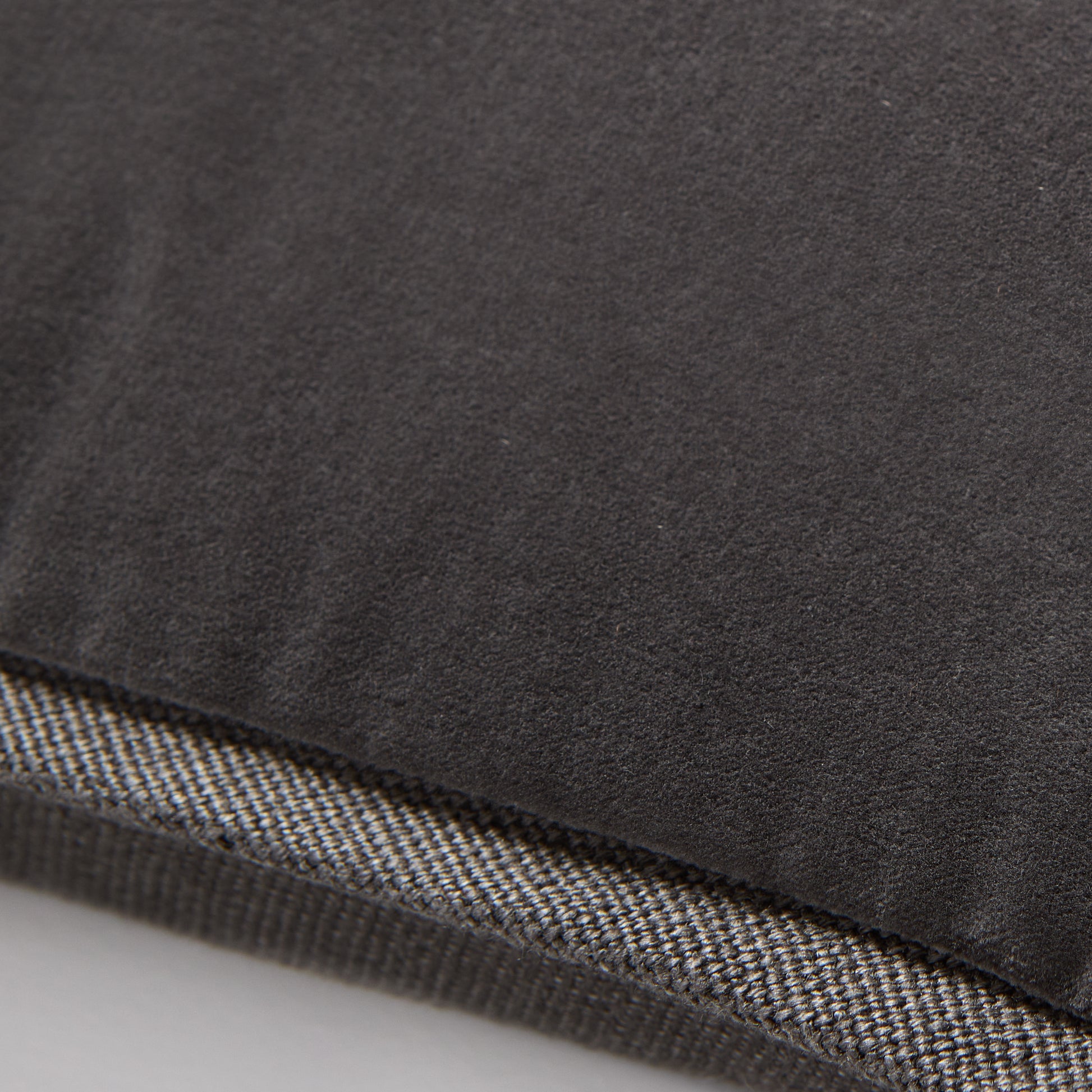 Slate grey tonal reversible velvet and linen lumbar pillow, 20"L x 14"H, with a hidden zipper.