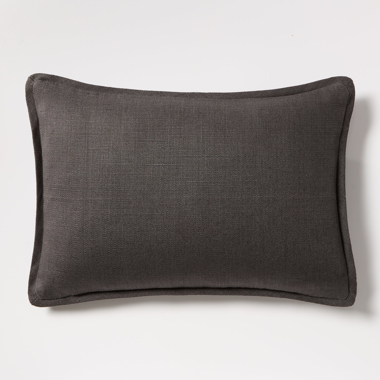 Slate grey tonal reversible velvet and linen lumbar pillow, 20"L x 14"H, with piped edges.