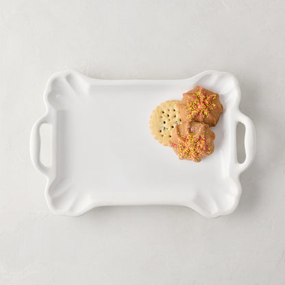 Small Alessia white ceramic handled serving platter with cookies.