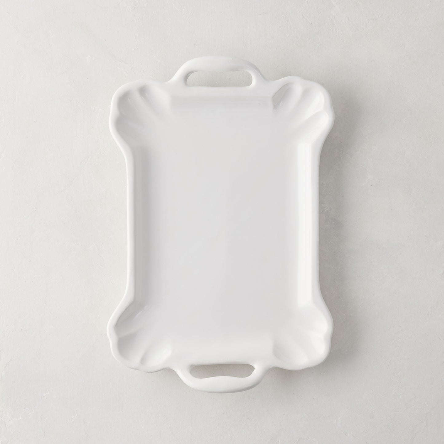 Small Alessia white ceramic handled serving platter with a delicate, vintage-inspired design and detailed edge.