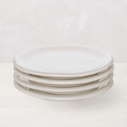 Stack of four white HG Appetizer 6.5" earthenware small plates with a low lip.