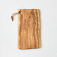 Artisan olive wood rectangular serve board with natural grain and leather hanging cord.