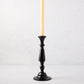 Small black lacquer Georgian candlestick with a cream taper candle.