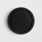 Small round black reclaimed pine wood serving tray with raised rim.