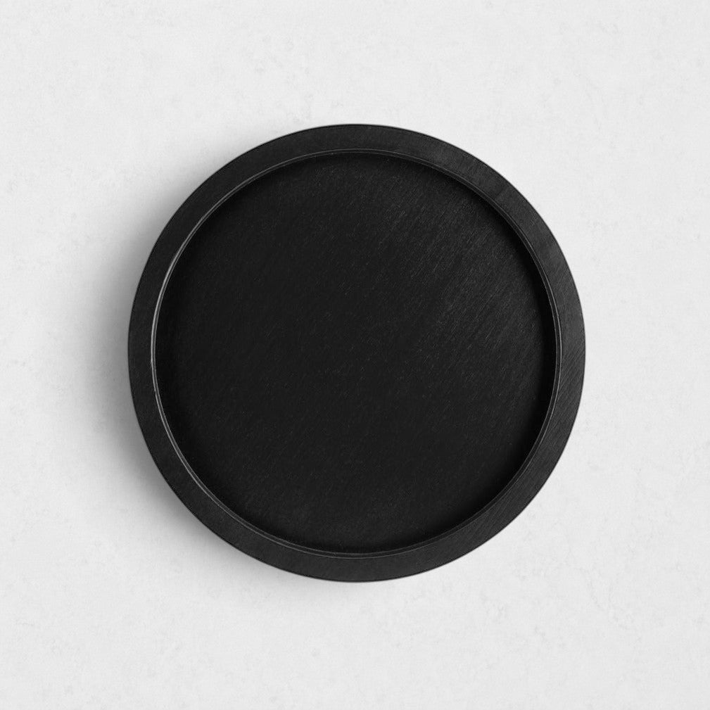 Small round black reclaimed pine wood serving tray with raised rim.