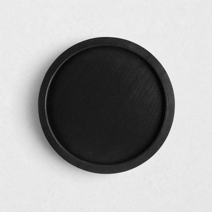 Small round black reclaimed pine wood serving tray with raised rim.