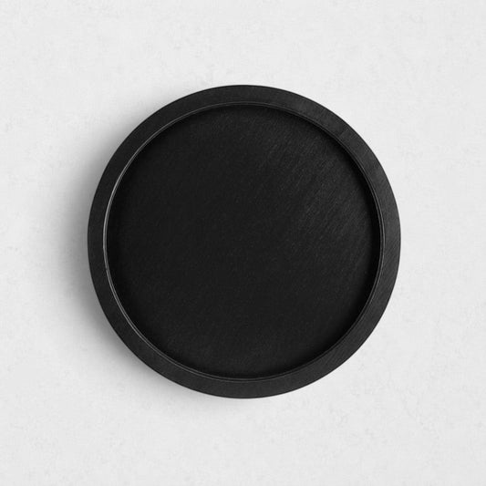 Small round black reclaimed pine wood serving tray with raised rim.