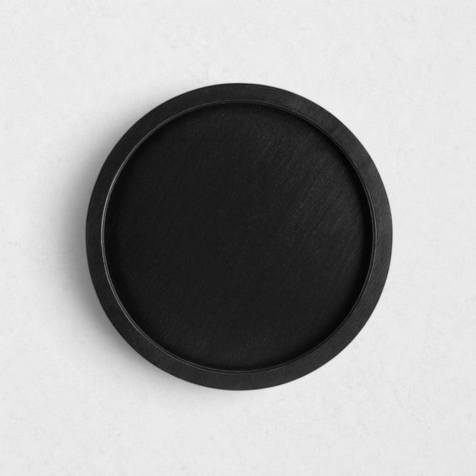 Small round black reclaimed pine wood serving tray with raised rim.