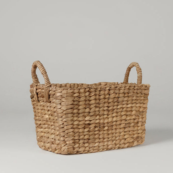 Small rectangular woven water hyacinth basket with two handles.