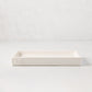 White ceramic rectangular tray with an understated lip and "HG" monogram.