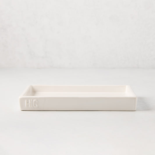White ceramic rectangular tray with an understated lip and "HG" monogram.