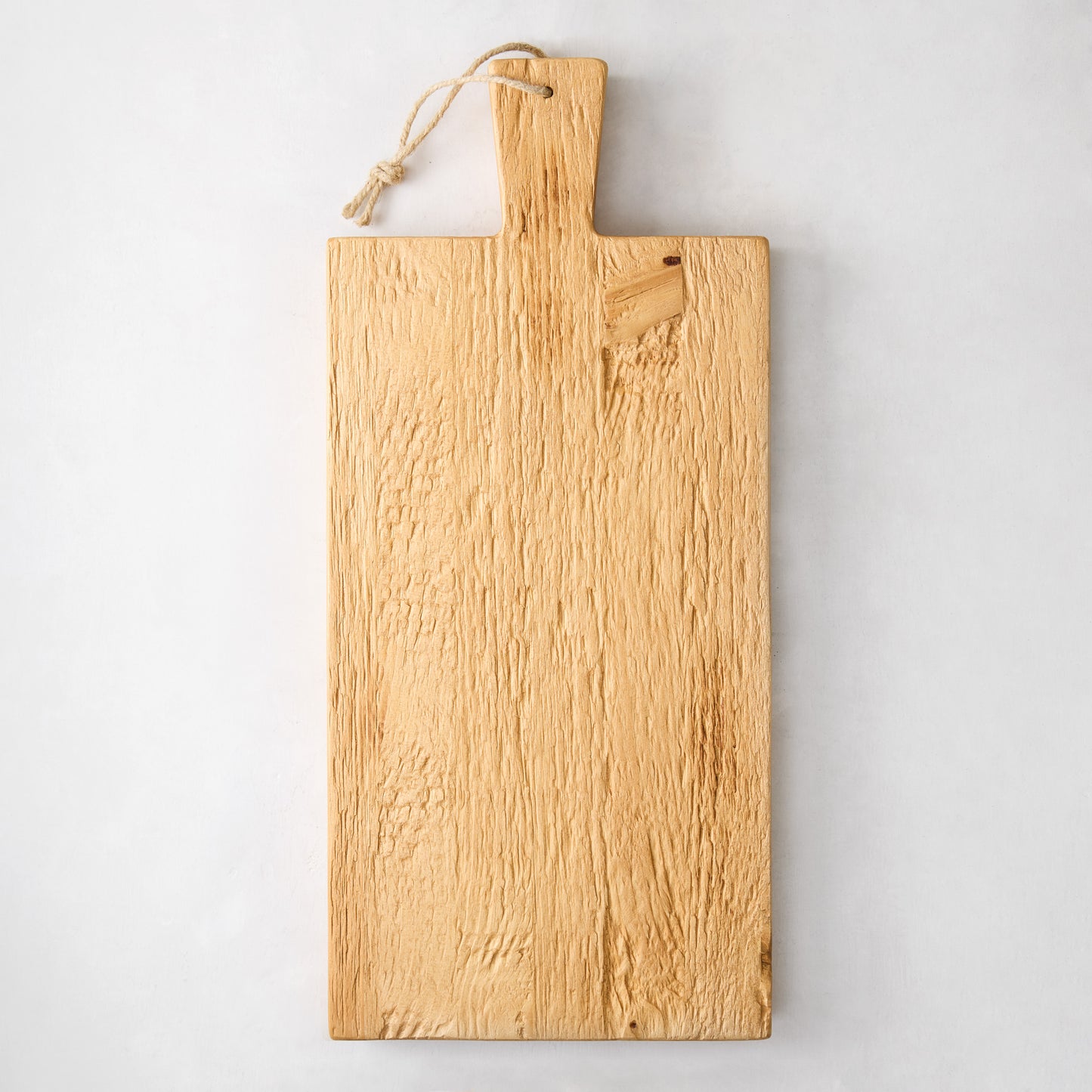 Hand-carved European pine serving plank, light wood grain, with a rope hanger.