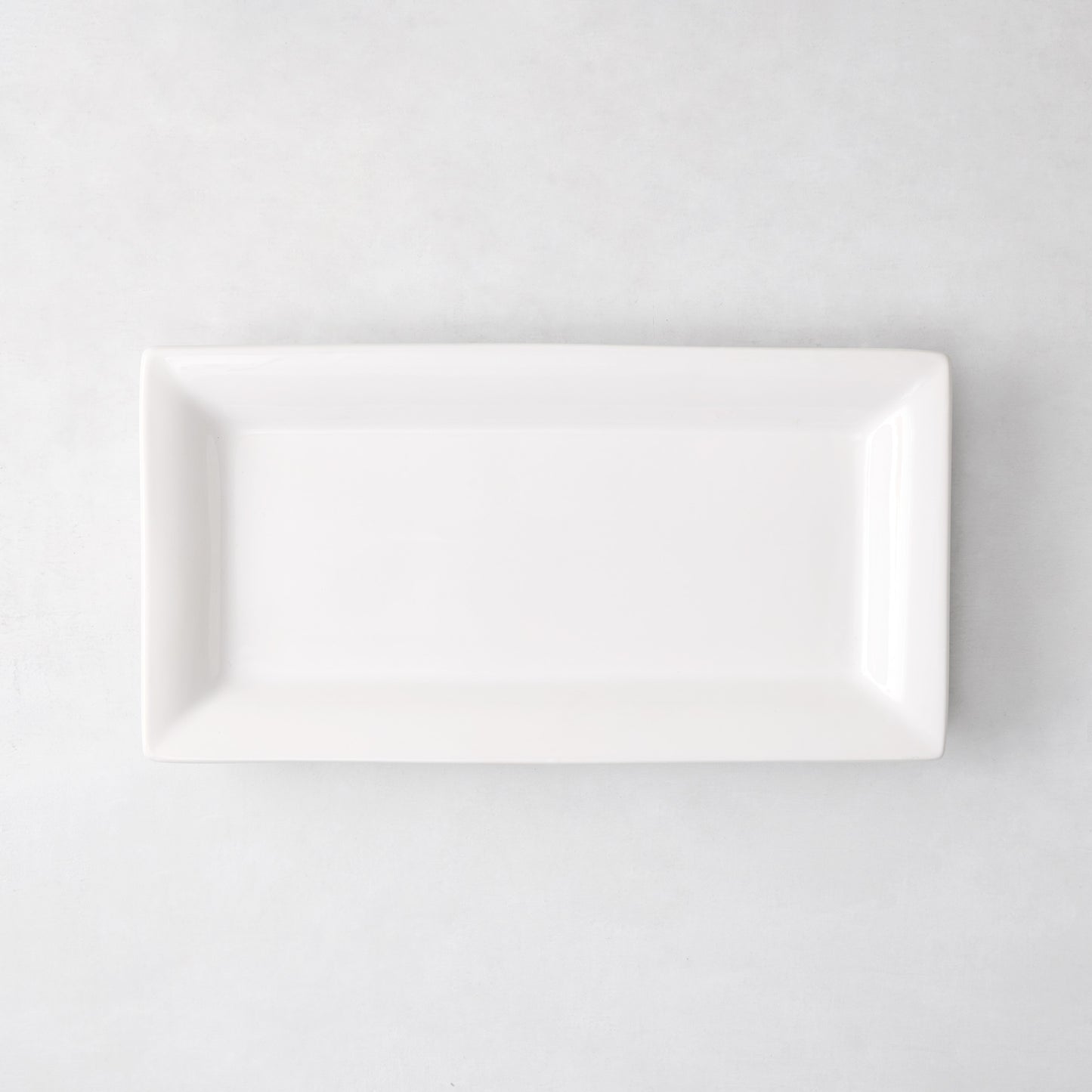 Small Lucca rectangular serving platter, white ceramic, 17"L x 9"W, modern sleek design.