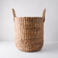 Small Montauk Woven Hyacinth Round Basket, natural brown, with two braided handles.
