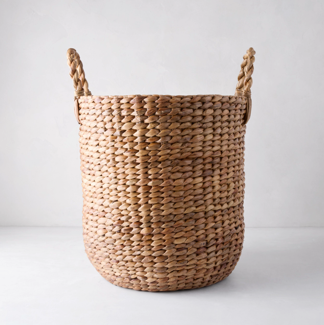 Small Montauk Woven Hyacinth Round Basket, natural brown, with two braided handles.