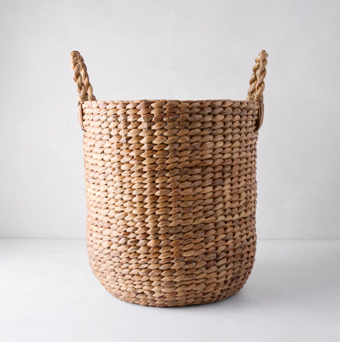 Small Montauk Woven Hyacinth Round Basket, natural brown, with two braided handles.