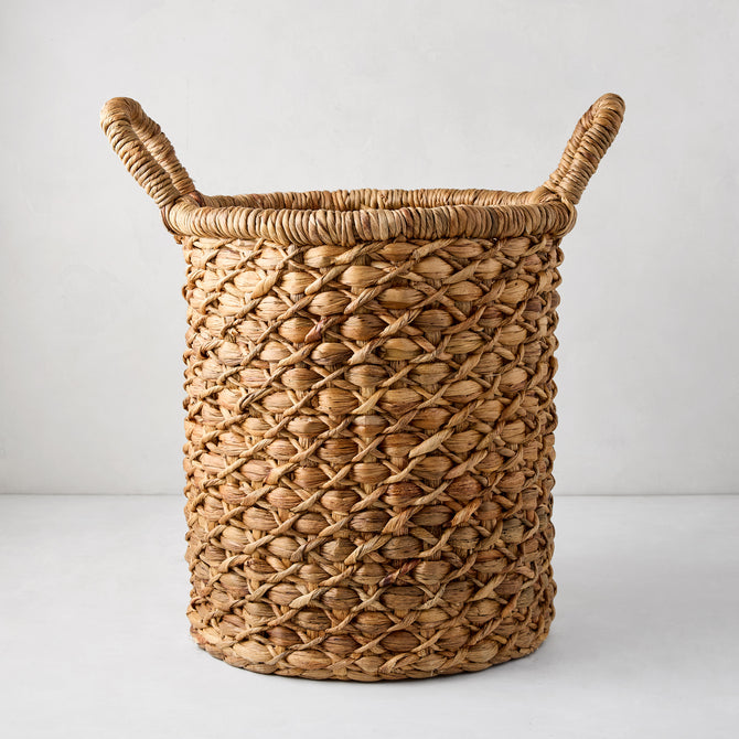 Handwoven round hyacinth leaves basket with natural brown tone and two top handles.