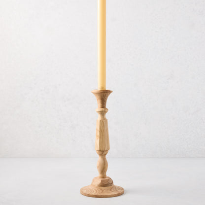 Small natural beechwood Georgian candlestick, 11"H, with a cream taper candle.