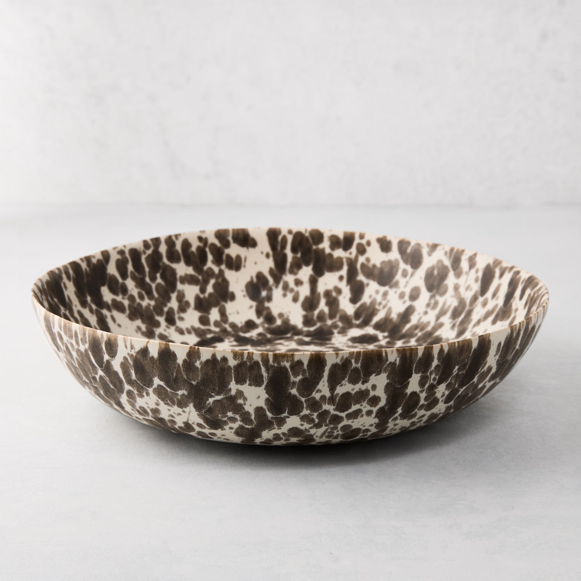Nuno Splatter stoneware serve bowl, 12"Dia, with brown spots on a pale cream base.