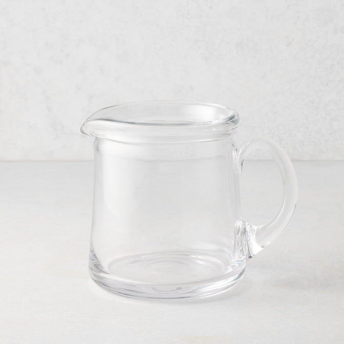 Small Oxford clear glass pitcher with a hand-molded rim and handle.