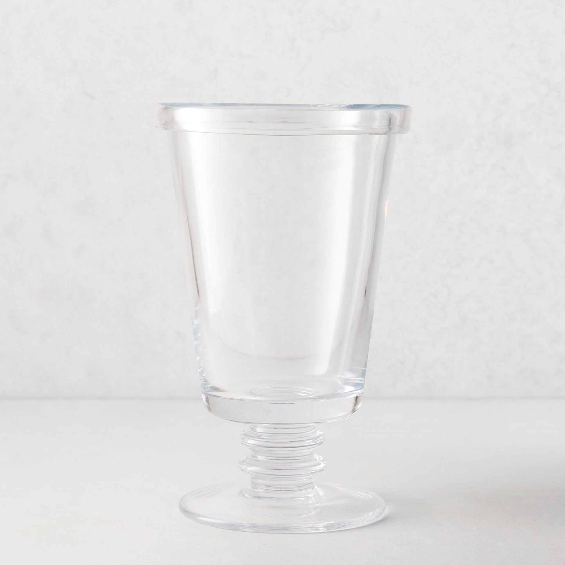 Small Oxford Glass Vase, clear with hand-molded rim and ribbed pedestal base.