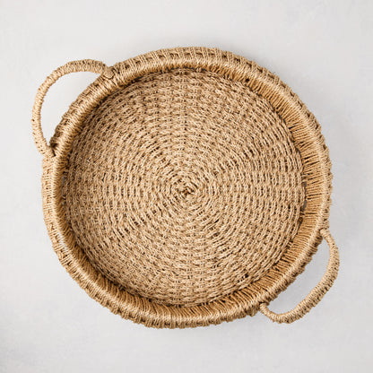 Small round woven abaca handled tray, natural brown, 16.5"Dia, with integrated handles and spiral weave.